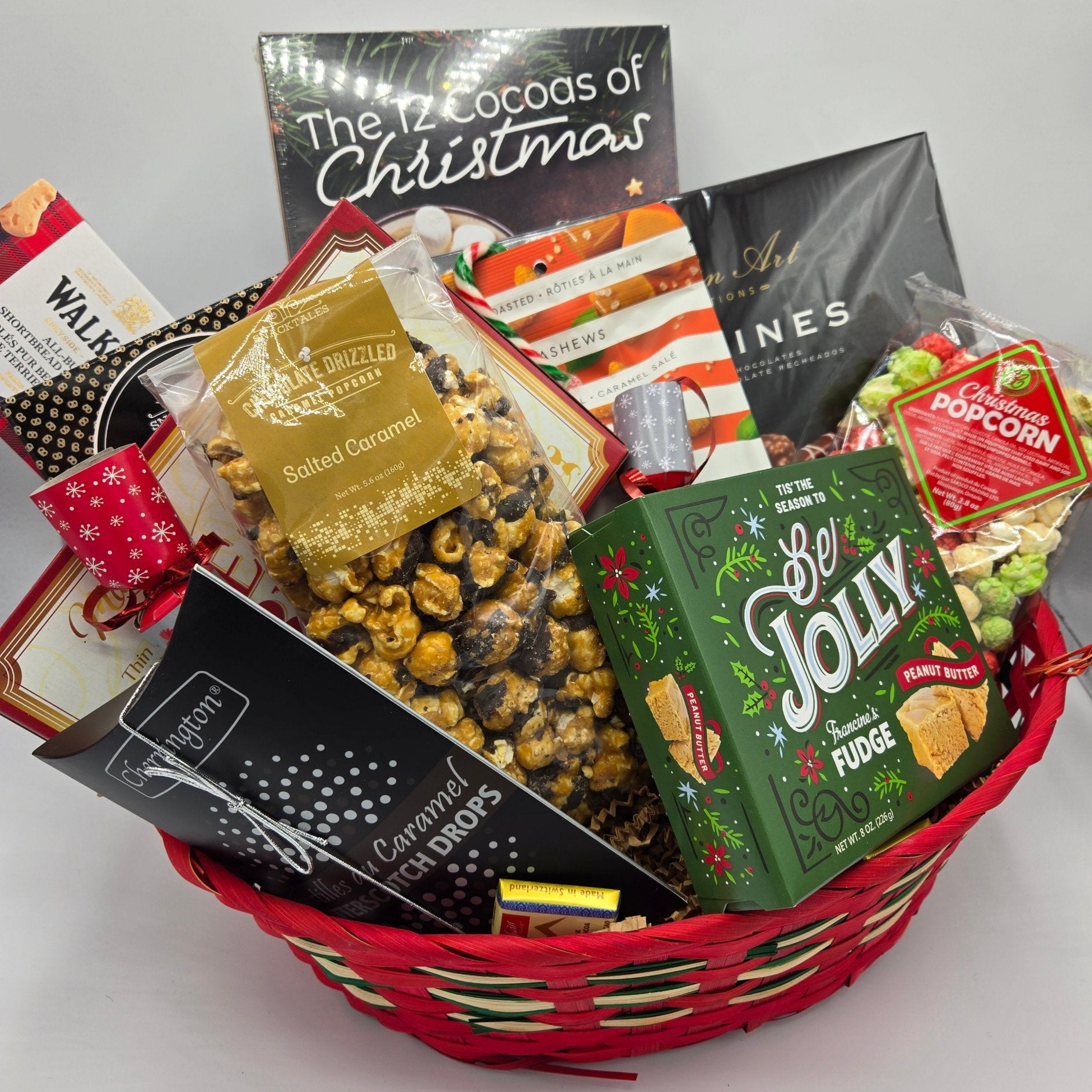 Holiday basket with a variety of sweet and savoury treats in a festive basket.