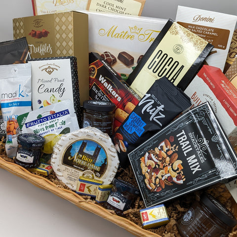 Deluxe Basket, a variety of sweet and savoury treats in a rectangle wicker basket.