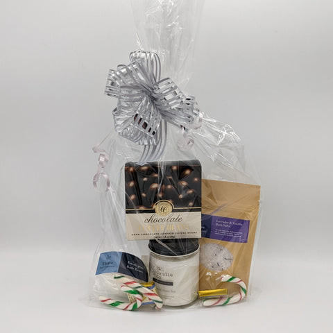 Spa cello gift with F&L soy candle, Thrive bath salts and bath bombs, and a chocolate treat.