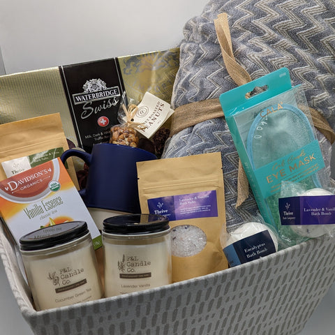 Ultimate care basket, the complete spa package with fuzzy blanket and a variety of products in a fabric basket.